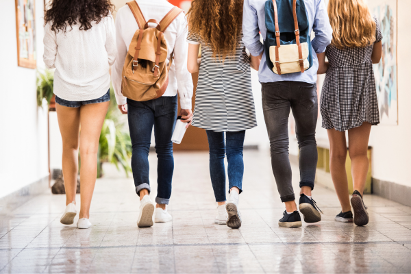 Students with backpacks walking down the hall