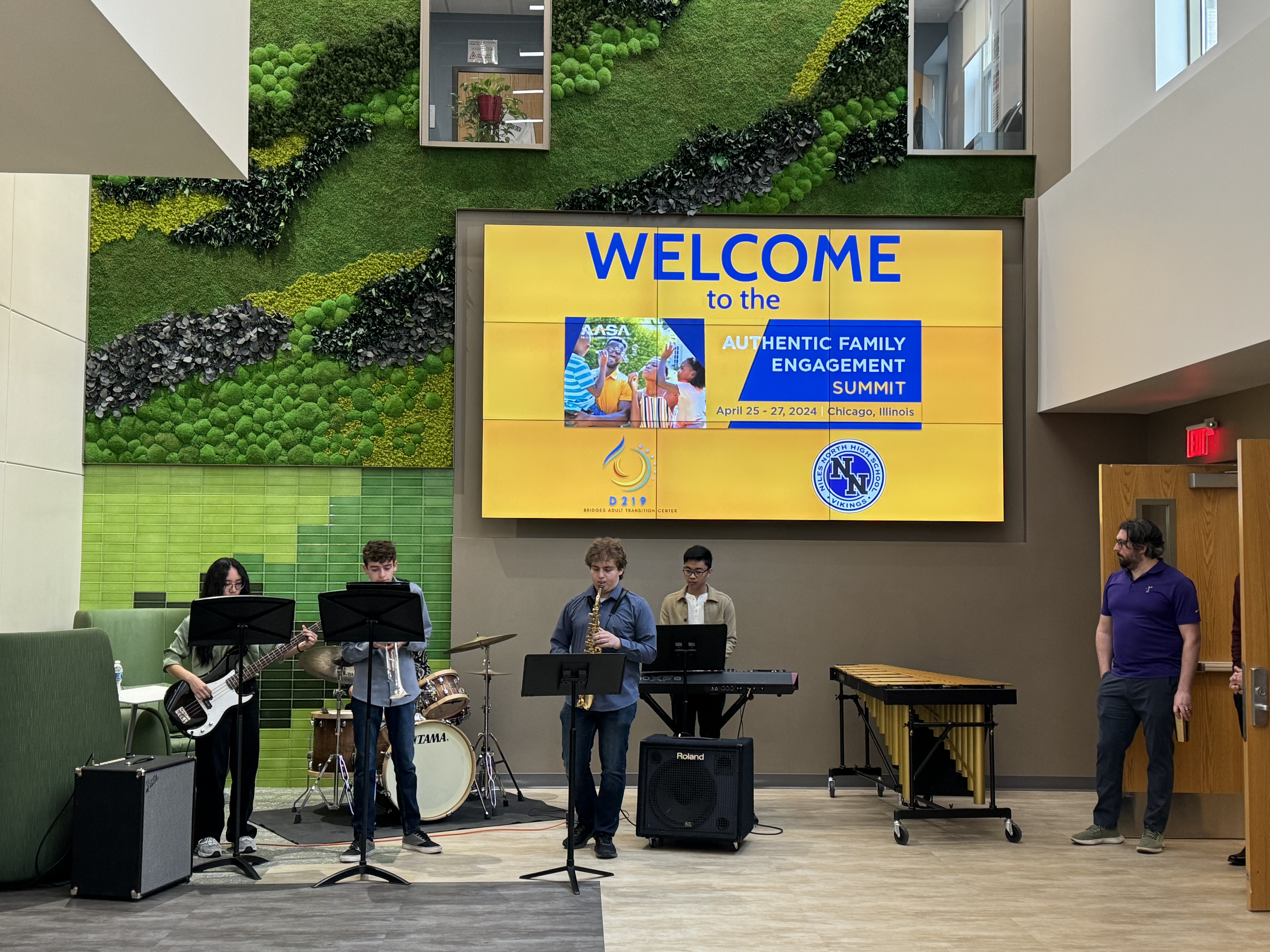 Student band players welcoming attendees to the building