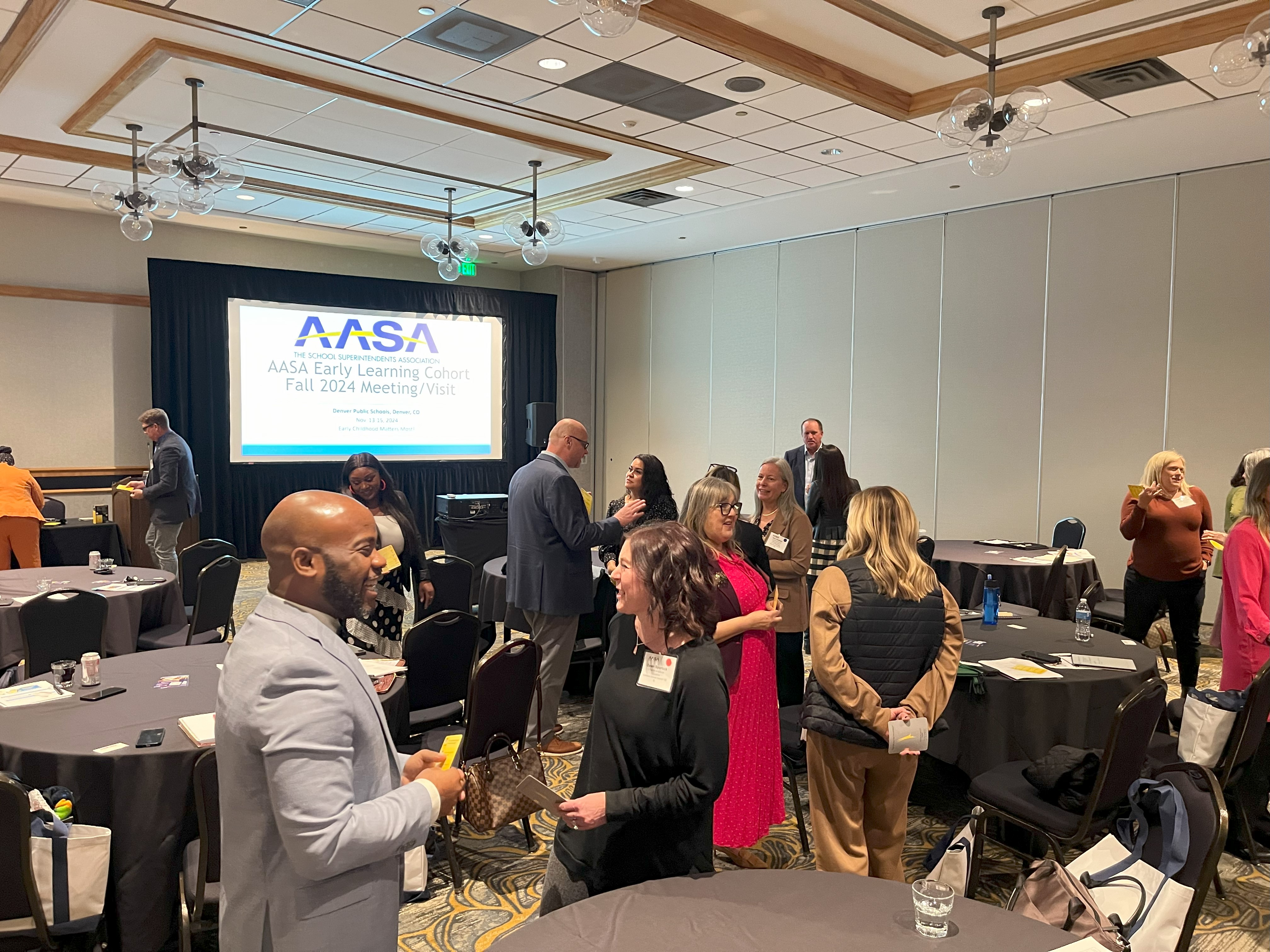 Attendees mingling in a conference room.