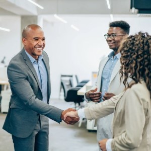 Man shaking hands with woman