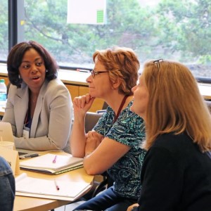 Three women chatting around a table