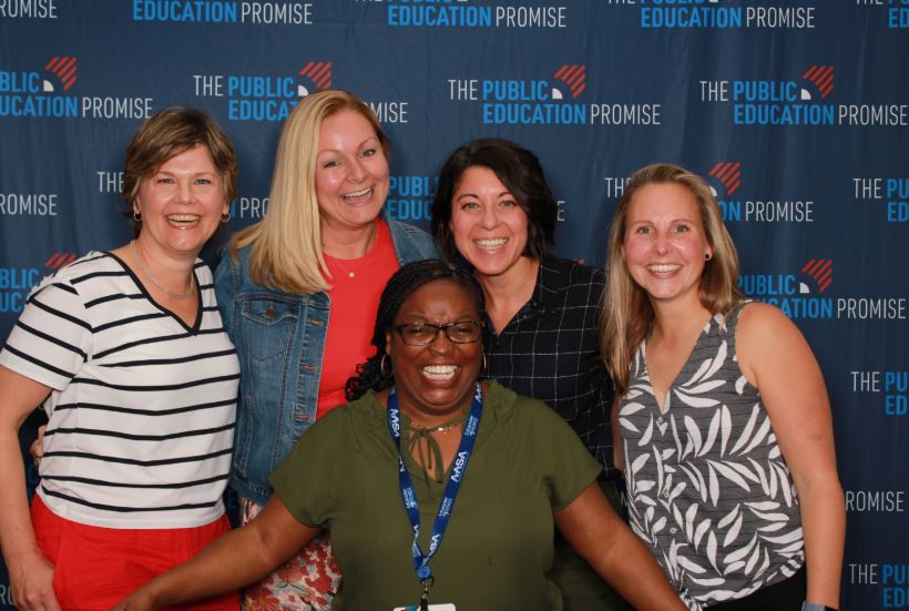 EdLeader Promise Network Team Members pose with The Public Education Promise banner