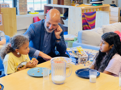 Gothard visiting with students as they eat lunch