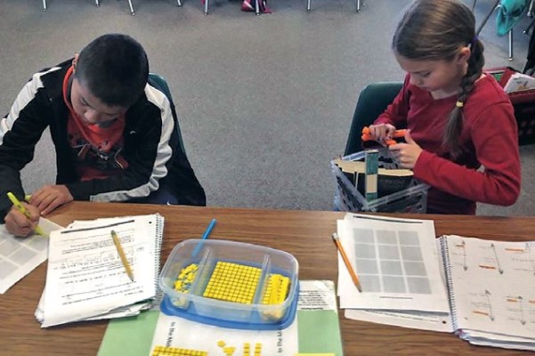 Students working on math with free supplies harvested online 