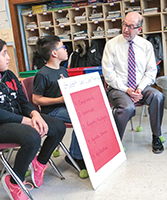 Superintendent David Gamberg observes a student-led class meeting in which students learn civil discourse.