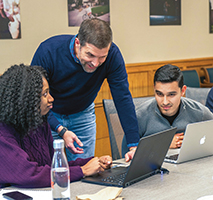 Seth Allen (standing), dean of admissions and financial aid at Pomona College in Claremont, Calif., believes standards-based grades could help his staff better assess applicants’ high-level analytical skills.