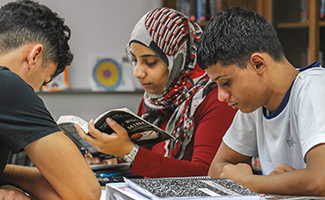 Three sdtudents reading books