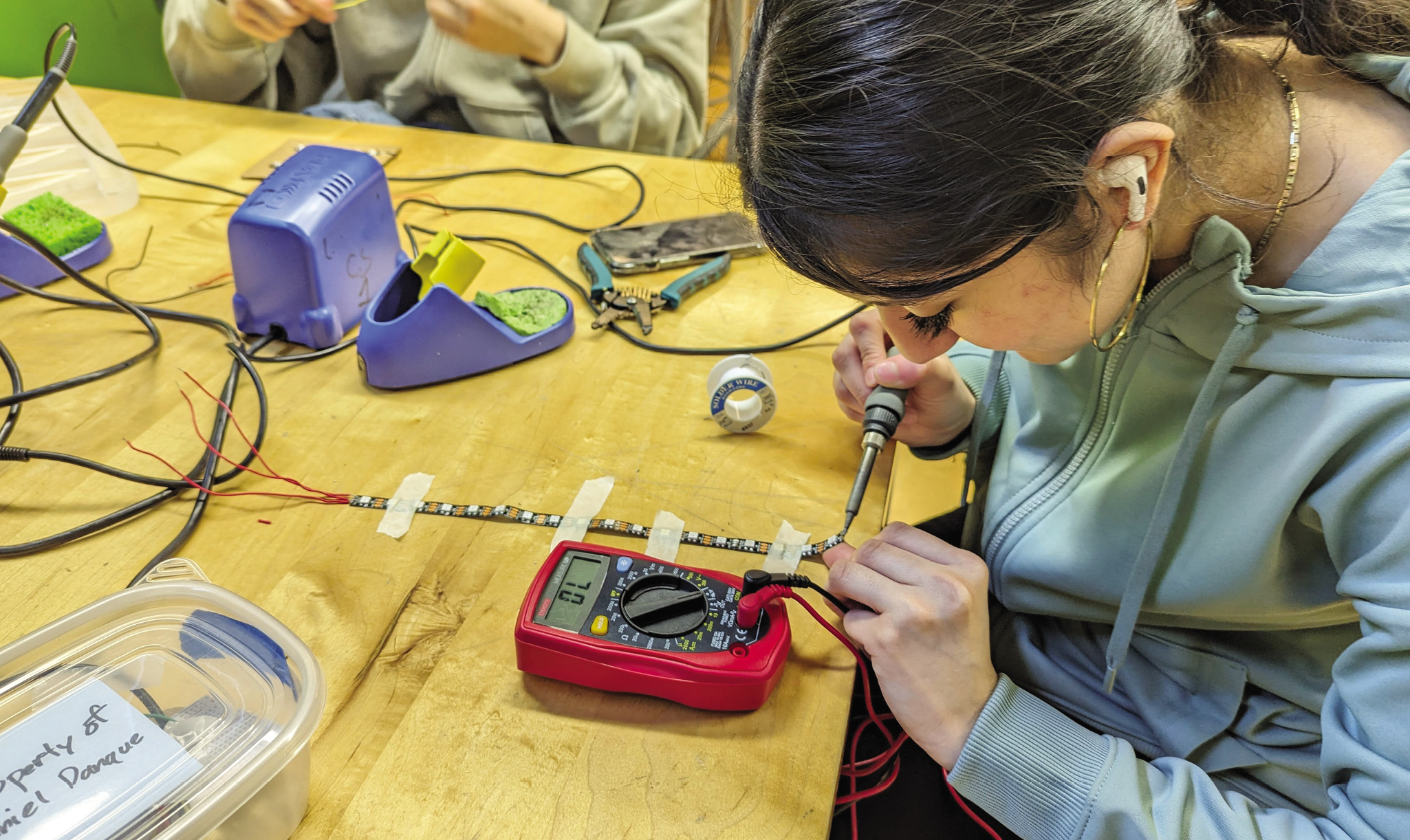 A teen student works on an electric project