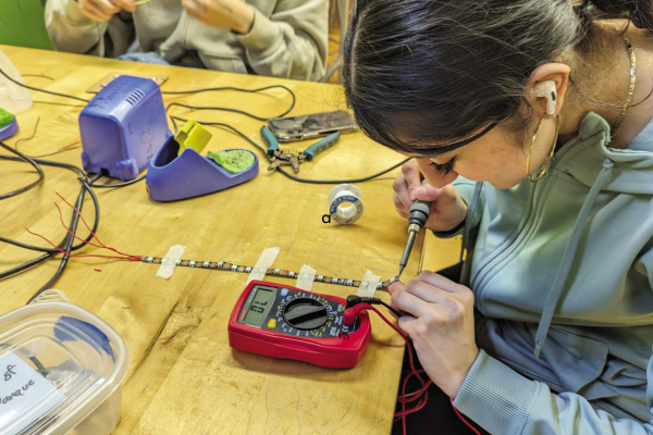 A student working on creating LED lights