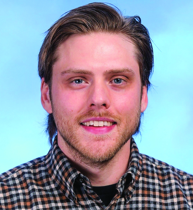 Nick LeClair, a white man with light brown hair, smiling, wearing a plaid shirt