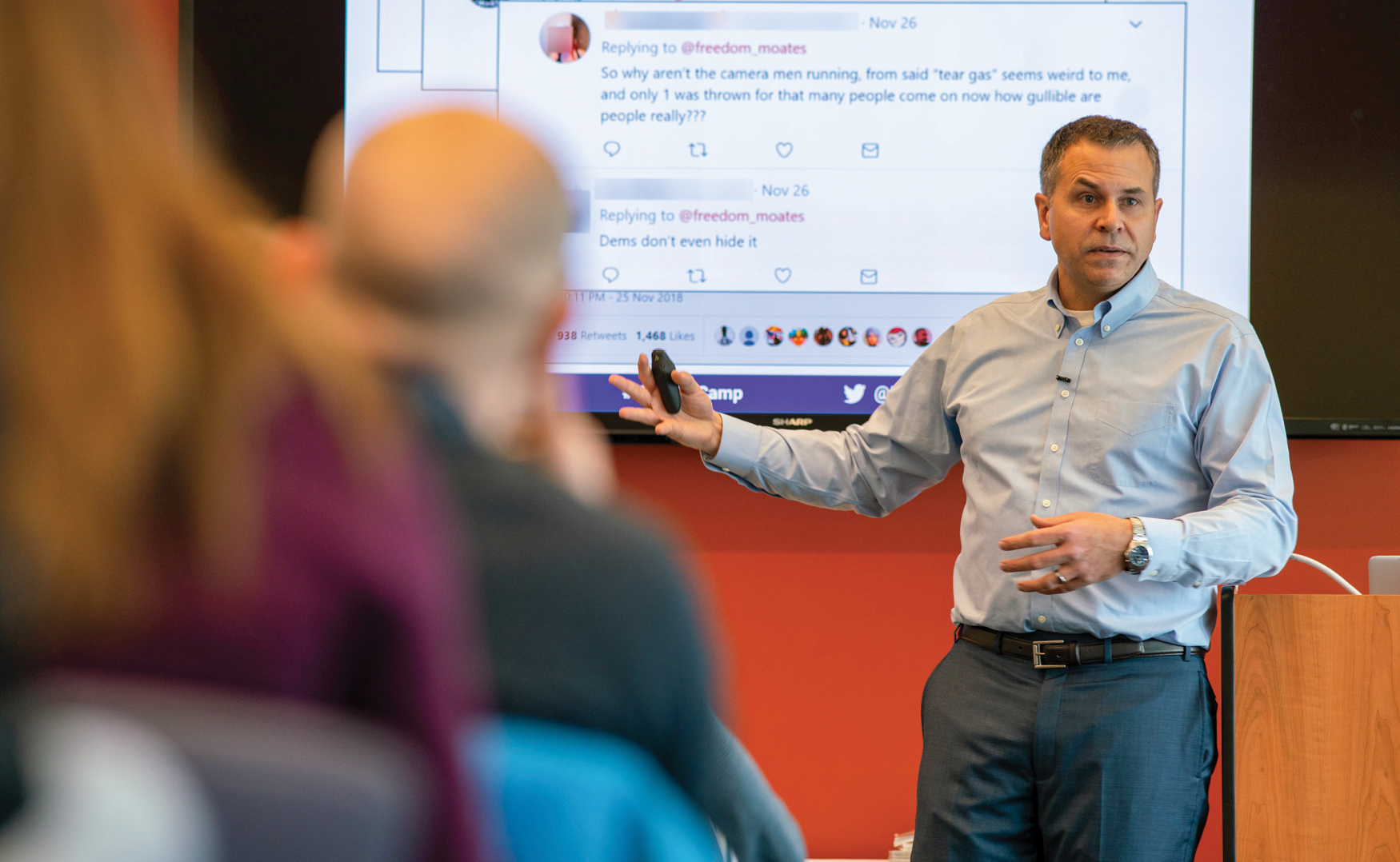 Peter Adams presenting in front of a PowerPoint screen