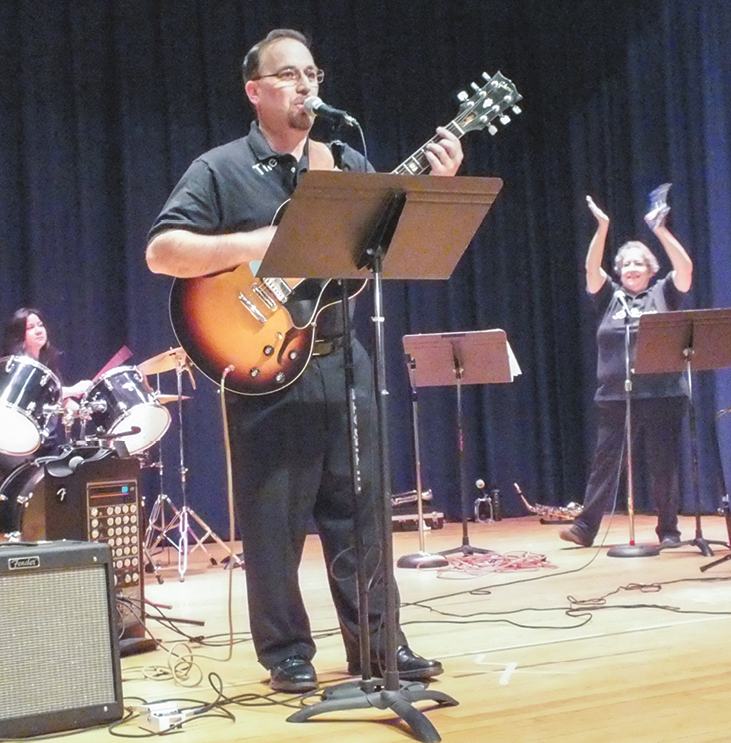 Joseph Famularo playing guitar and singing