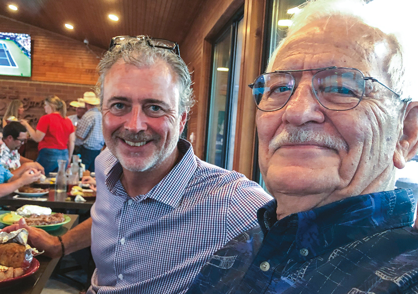 A middle-aged man with his father, taking a selfie