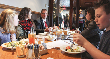 Jason Andrews (center), shown hosting a lunch for student council presidents in the Windsor, N.Y., district, studied shared superintendencies in his doctoral dissertation.